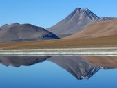 Sopka Pili (také Acamarachi - 6046m) odrážející se v hladině laguny Quepiaco, Chile