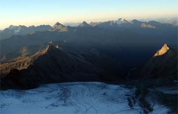 Vycházející slunce nad alpskými vrcholky západně od Grossglockneru během výstupu hřebenem Stüdlgrat (3500m).