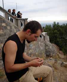 Vladimďż˝ sitting and peeling the nopal on San Cristobal hill, Chile, 26. 2. 2006